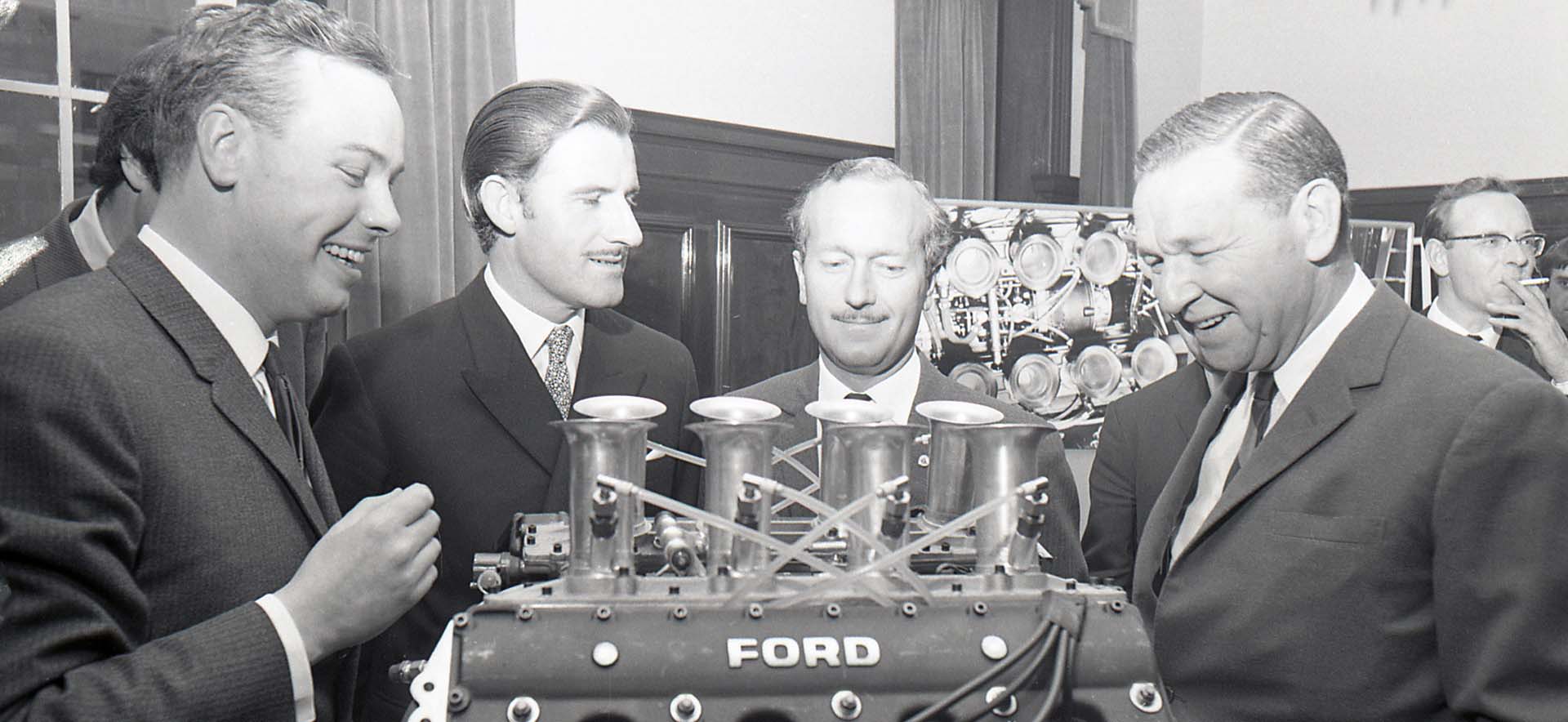 V8 engine with engineers around it