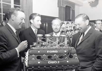 V8 engine with engineers around it