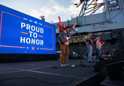 Band on stage with PTH behind