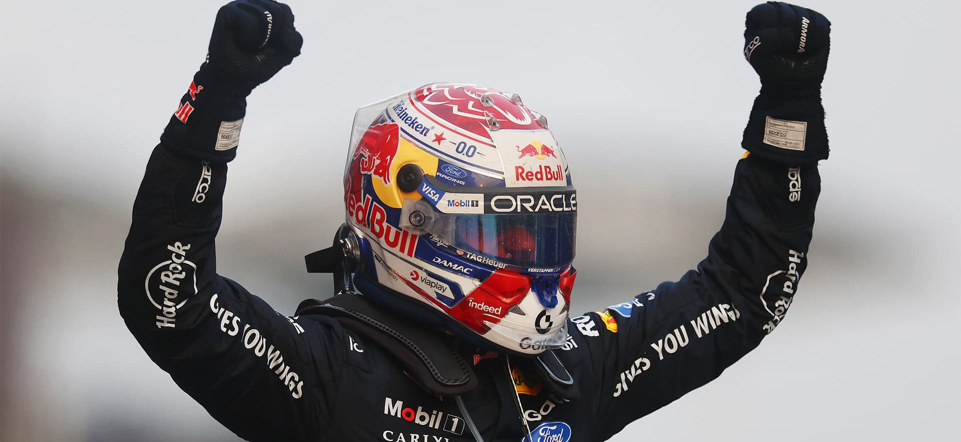 Max on podium with hands up