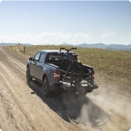 Ford truck in motion on dirt road