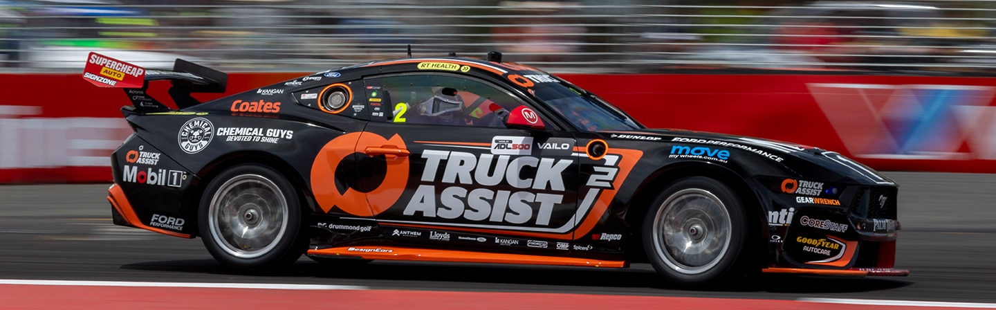 Ryan Wood’s orange and black number 2 Ford Mustang GT race car on track