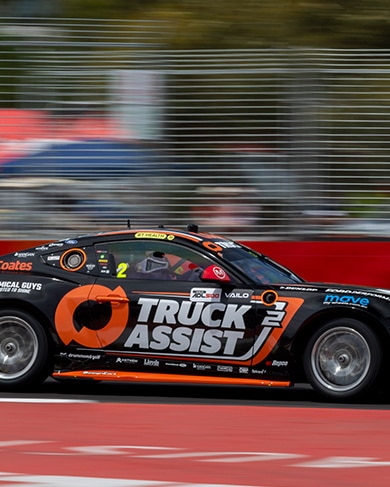 Ryan Wood’s orange and black number 2 Ford Mustang GT race car on track