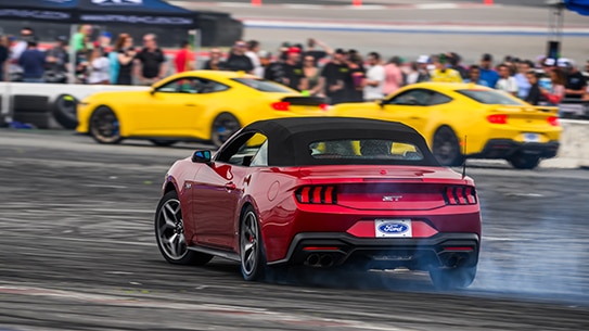 Red Ford car driving on race track