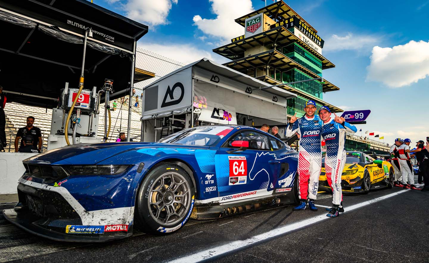 drivers on track in front of mustang gt3