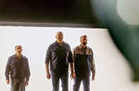 Ford engineers walking into a garage backlit by daylight