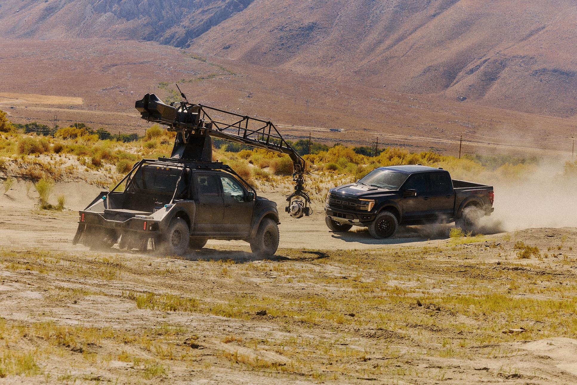 Truck mounted camera filming a Ford Raptor from the front