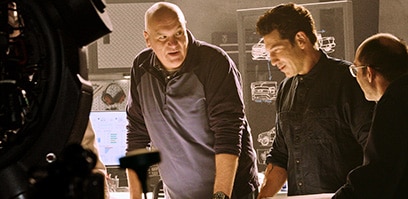 Derek Bier discussing engineering plans with Jon Bernthal