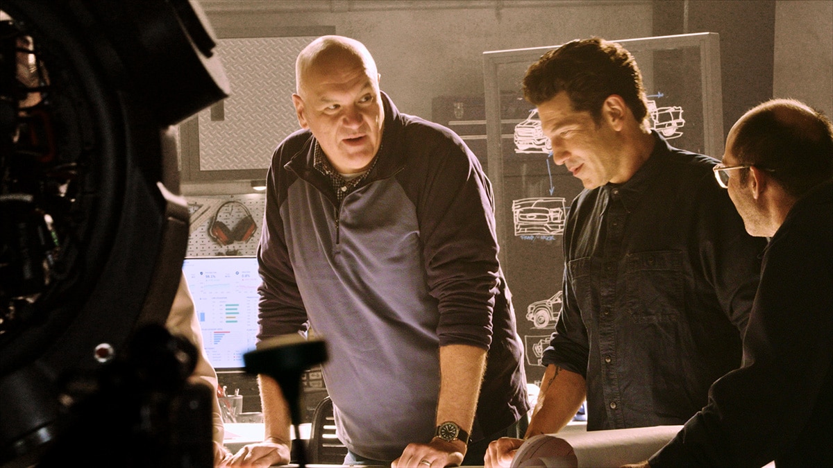 Derek Bier discussing engineering plans with Jon Bernthal
