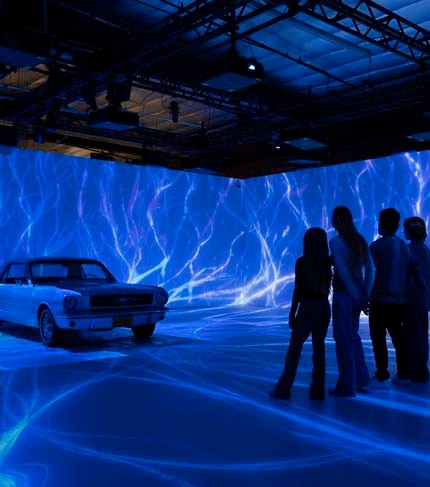 Spectators cheer on driver and race car