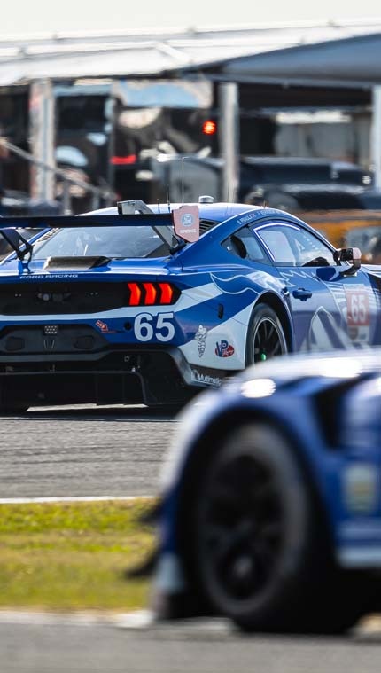 Race cars in motion on a racetrack