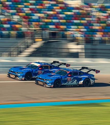 Race cars in motion on a racetrack