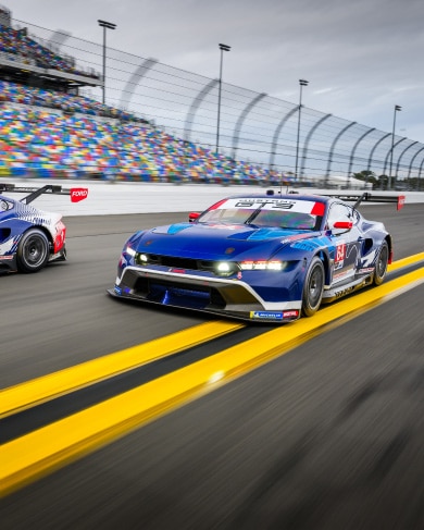 Race cars in motion on a racetrack