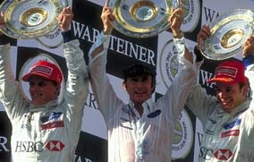 Johnny Herbert, Jackie Stewart, and Ruben Barrichello on podium in 1999