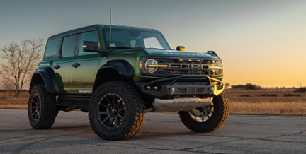 Bronco Raptor stationary against backdrop of sunset	