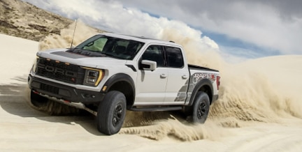 F-150 Raptor R in motion against a backdrop of sandy dunes