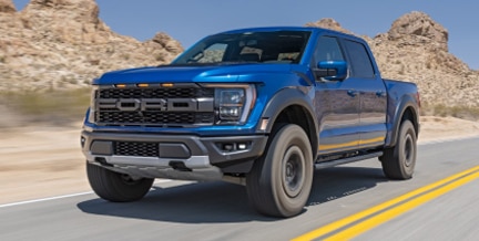 F-150 Raptor in motion against backdrop of mountains