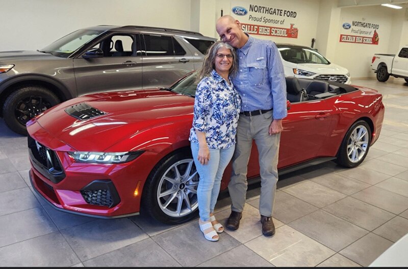 Couple standing by new 2024 Mustang