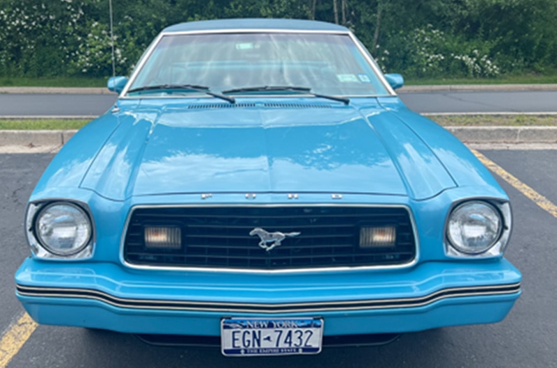 Blue Mustang II in parking lot