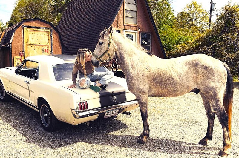 Sydney Lett sitting on Mustang with a Horse