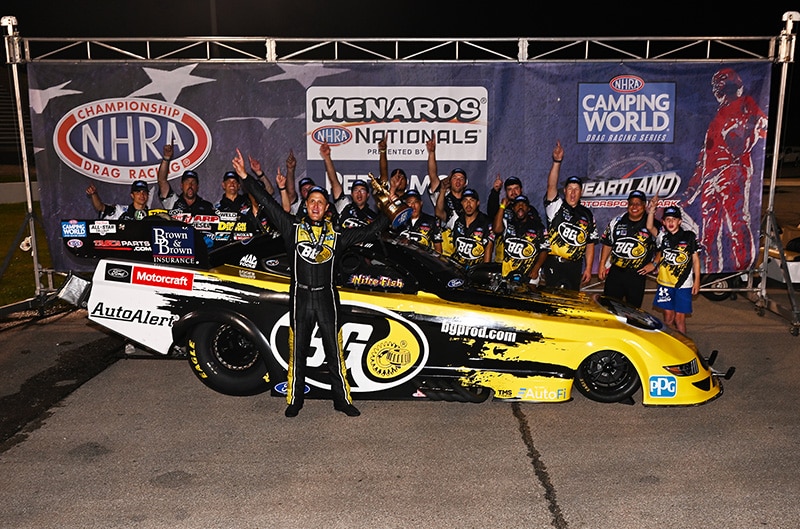 Bob Tasca III Standing with trophy and Drag Car