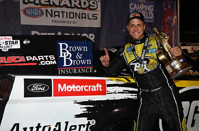 Bob Tasca III posing next to drag car with Motorcraft logo