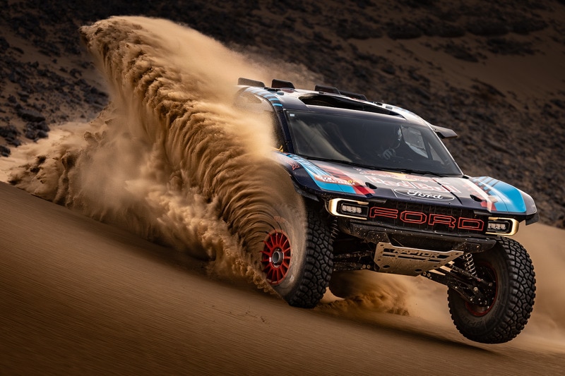 Ford Raptor T1+ throwing sand in dunes