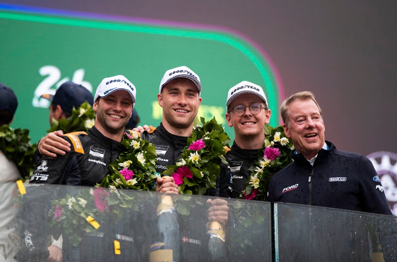 Team at podium with bill ford